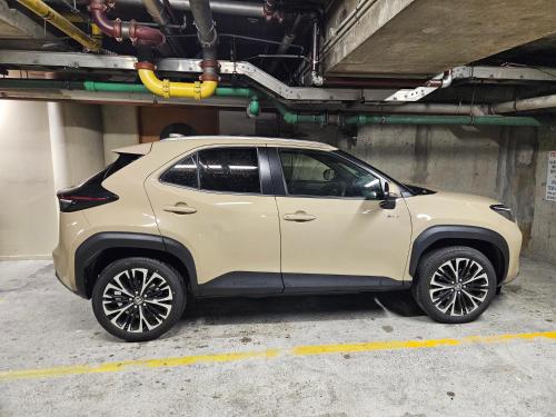 a tan suv parked in a parking lot at Top Floor - Free Parking - Central Location - Quiet - City View in Wellington
