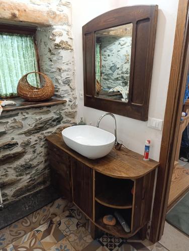 a bathroom with a sink and a mirror at Villa Art Razzamir in Ponte di Nava