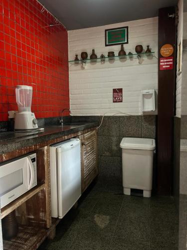 a kitchen with a sink and a toilet in it at Economy Flat in Natal