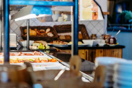 a buffet line with a lot of food on display at Bei Max - Hotel Garni Kirchenwirt in Sankt Leonhard im Pitztal