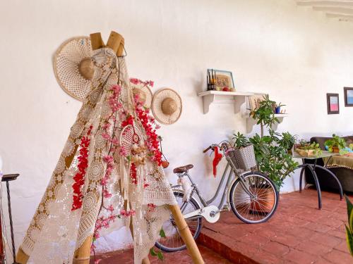 a dress and a bicycle in a room with a fan at CASA MAGIA by Magally Velasco in Curití