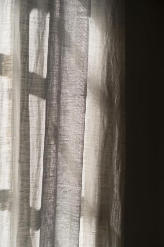 a close up of a window with white curtains at Mas de Monge in Tarascon