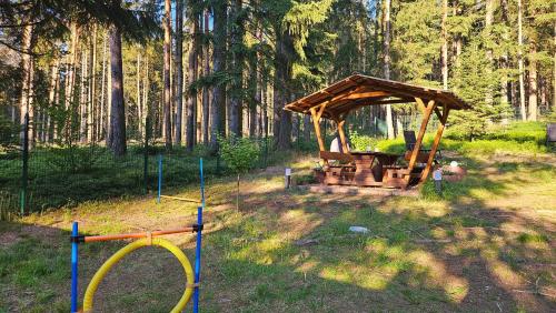 a wooden gazebo in the middle of a forest at Thüringer Waldbaude in Tambach-Dietharz