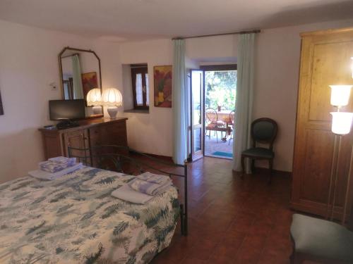 a bedroom with a bed and a mirror and a door at Villa Pilar in Toscana con piscina ultrapanoramica in Montevettolini