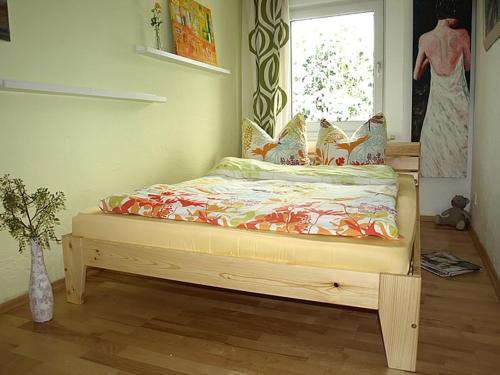 un lit assis dans une pièce avec une fenêtre dans l'établissement Ferienwohnung Sorpesee, à Sundern