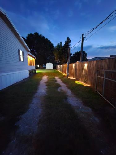 a dark yard with a fence and a house at Fisherman's Hideaway! Home on canal in Okeechobee! in Okeechobee