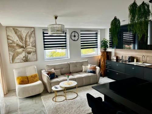 a living room with a couch and a table at Violet Suite in Nyíregyháza