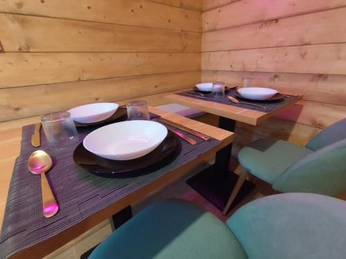 a wooden table with plates and bowls on it at MarLee Mountain Home in Pizzone