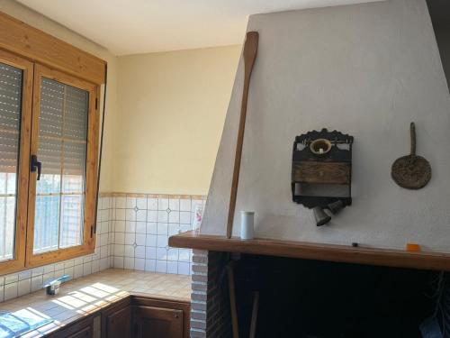a kitchen with a fire place in a room at Cortijo Los Periquitos 