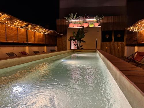 a swimming pool at night with lights at BELLADORA Hotel Boutique in Lloret de Mar