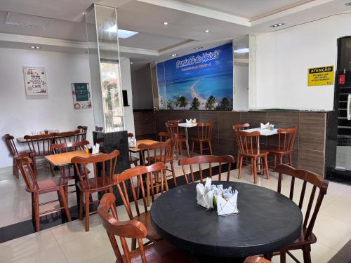 a dining room with a table and chairs in a restaurant at Pousada Solare in Maragogi