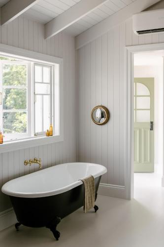 a bath tub in a bathroom with a window at Maleny Lodge in Maleny