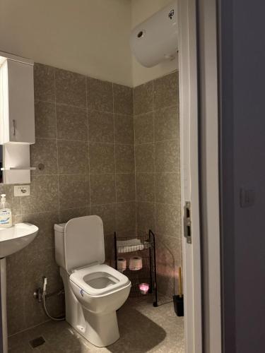 a bathroom with a toilet and a sink at Adriatic Suite 101 Taulantia Seafront Stay in Durrës