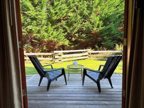 a patio with two chairs and a glass table at Painter's Lodge in Campbell River