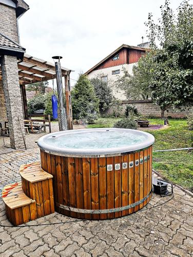 a hot tub in a yard with benches around it at Urusel Hostel in Tallinn