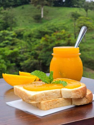 a slice of bread with a jar of orange sauce at Burbi Lake Lodge Monteverde in Monteverde Costa Rica