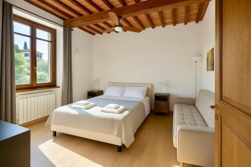 a bedroom with a bed and a couch at Villa La Gioconda in Arezzo
