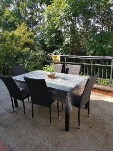 a table with four chairs and a table with a table cloth at Vacanza nel boschetto in Narni