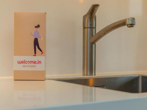 a box sitting on a counter next to a kitchen sink at Coastal Comfort in Zoutelande in Zoutelande
