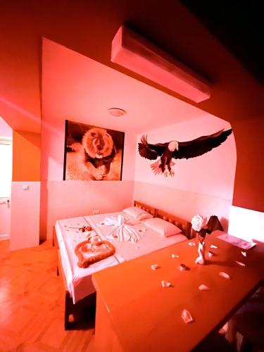 a bedroom with two beds with an eagle on the wall at Casa BB&Djassi - Rooms in Ponta do Sol