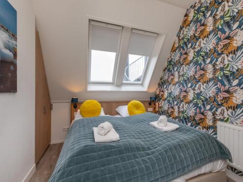 a bedroom with a bed with two towels on it at Wifi and golden beaches Home in Zoutelande
