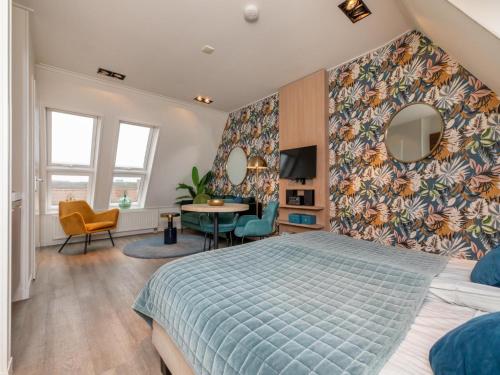 a bedroom with a bed with a blue bedspread at Romantic stay near Zoutelande in Zoutelande