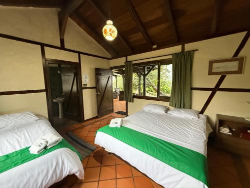 a bedroom with two beds in a room at Tambo Quinde in Tandayapa