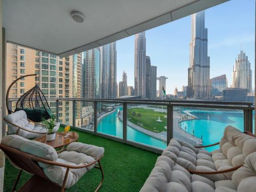 a balcony with chairs and a view of a city at Panoramic Burj 5br Condo with Full Led & Fountain View in Dubai