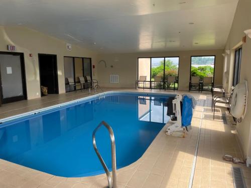 a large swimming pool with blue water in a building at Holiday Inn Express Hotel & Suites Charleston-Southridge by IHG in Charleston