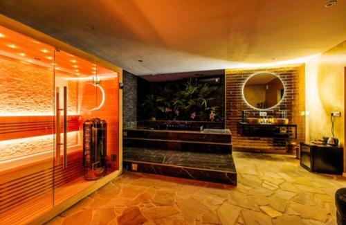 a bathroom with a shower and a mirror in a room at Privespa Calma in Tilburg