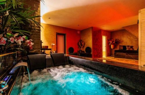 a swimming pool in a hotel room with a water feature at Privespa Calma in Tilburg