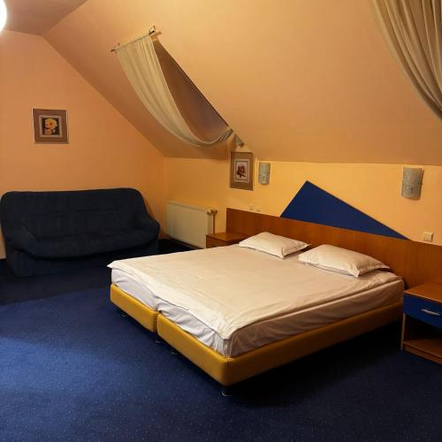 a bedroom with a large bed and a couch at Vila Daria in Braşov
