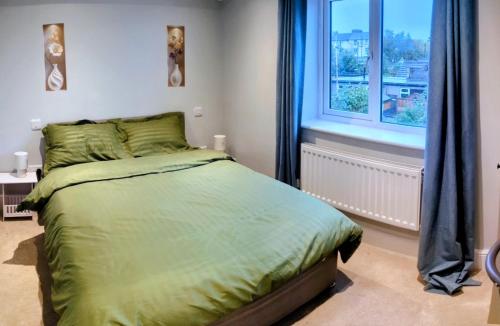 a bedroom with a bed and a window at Room in Swanscombe, Kent in Swanscombe
