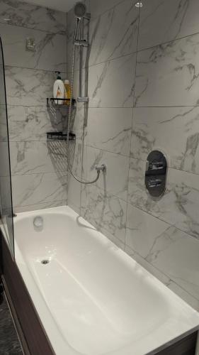 a bathroom with a shower with a tub and a sink at Room in Swanscombe, Kent in Swanscombe
