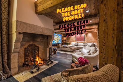 a lobby with a fireplace with a sign that reads please read thejust provide at Luxuriöses Zermatt Chalet mit Pool & Jacuzzi in Zermatt