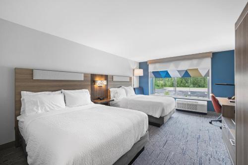 a hotel room with two beds and a window at Holiday Inn Express & Suites Marinette in Marinette