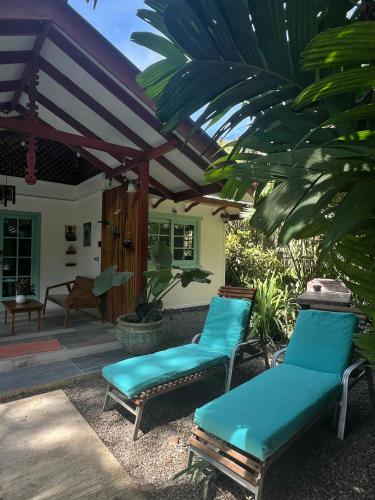 two blue chairs sitting on a patio at Geckoes Lodge in Cocles