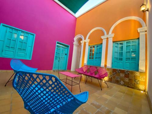 a room with colorful chairs and tables in a building at La Casa De Don Rámon in Guadalajara