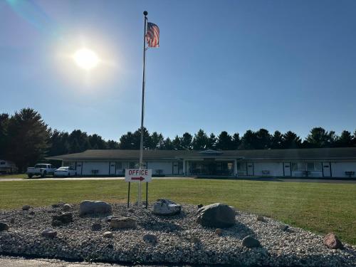 a flag pole with a sign in a field at Skyview Motel - Prairie du Sac in Prairie du Sac