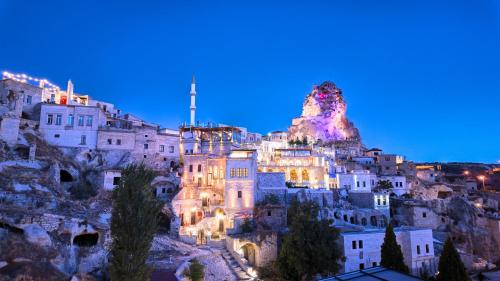 a group of buildings on a mountain at night at Anjelic Cave Cappadocia in Urgup