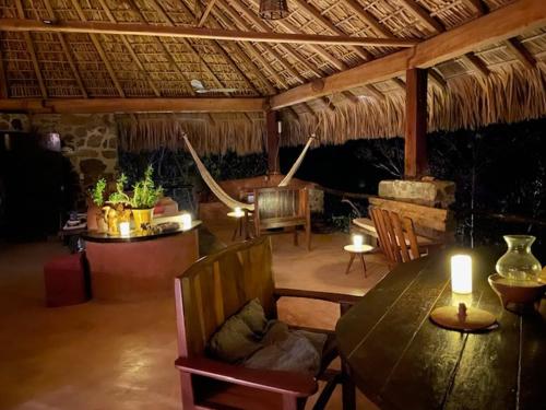 a dining room with a wooden table and chairs at Villa Nanami in Arroyo Cruz