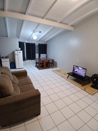 a living room with a couch and a table at Cobertura próximo a Oktoberfest! in Blumenau