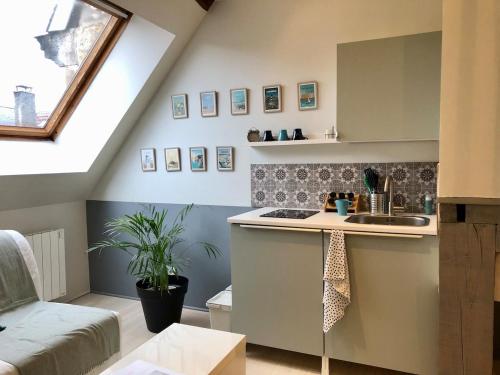 a kitchen with a sink and a counter top at City Escape Space in Chaumont