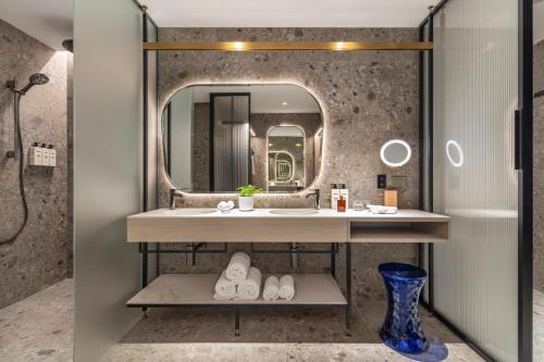 a bathroom with a sink and a mirror at Hotel Indigo Melbourne Little Collins in Melbourne