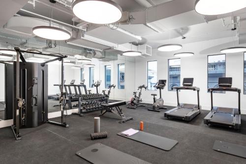 a gym with treadmills and elliptical machines at Hotel Indigo Melbourne Little Collins in Melbourne