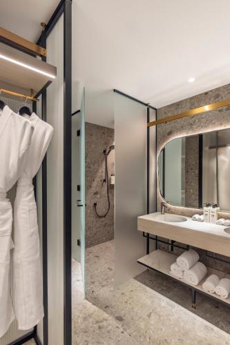 a bathroom with a sink and a mirror at Hotel Indigo Melbourne Little Collins in Melbourne
