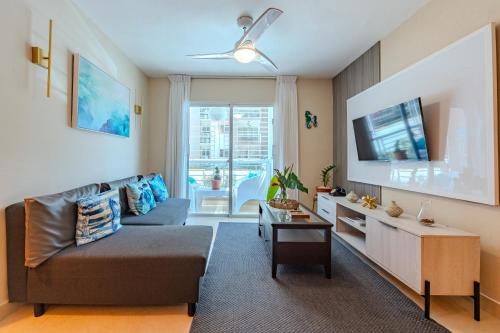 a living room with a couch and a tv at Oasis cerca del mar #1 in El Higo