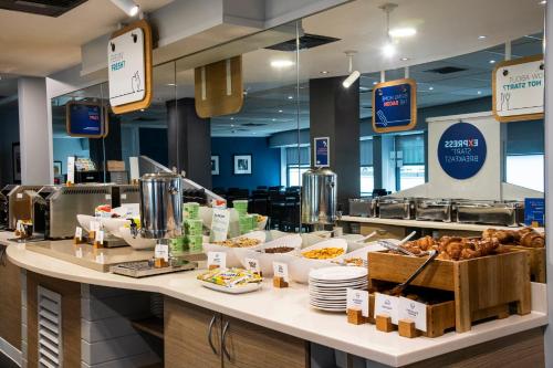 a bakery counter with bread and pastries on it at Holiday Inn Express - Glasgow - City Ctr Riverside by IHG in Glasgow