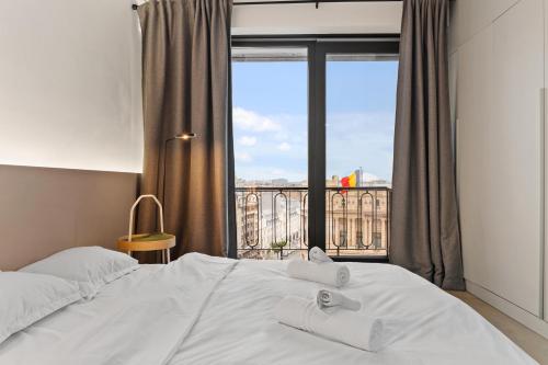 Ένα ή περισσότερα κρεβάτια σε δωμάτιο στο Calea Victoriei Panorama