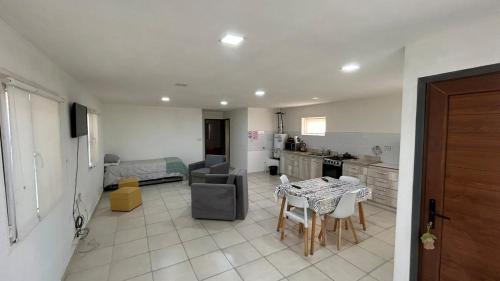 a kitchen and living room with a couch and a table at Casa Amplia in Río Grande